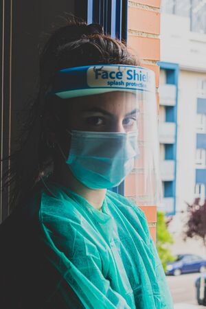 Doctor in PPE suit has stress in Coronavirus outbreak or Covid-19, Covid-19 Quarantine Concept. Emotional stress of doctor and health care team with overwork during Covid-19 period.の写真素材