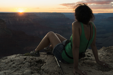 View of a girl watching sunset at Grand Canyon of Coloradoの写真素材