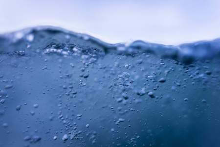 Fresh blue water with air bubbles, abstract wave isolated on white backgroundの写真素材