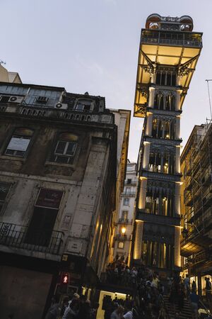 Lisbon, Portugal august, 2019: vertical photo of Sant Justa elevator Illuminated at night, seen from a street full of tourists in Baixa districtのeditorial素材