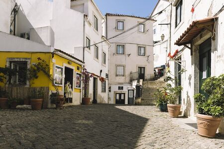 typical traditional portuguese cobblestone street in Lisbon, Portugalの写真素材
