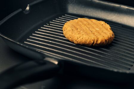 vegan burger cooking on the iron, vegetarian food and healthy lifestyle concept
