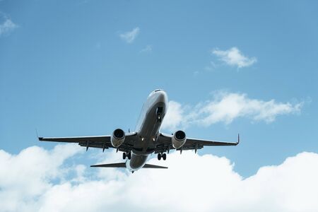 commercial airplane taking off in a clear sky with some clouds, travel concept, copy space for text