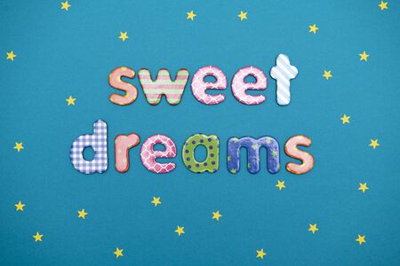 message sweet dreams on a blue background with yellow starsの写真素材