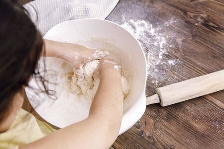 unrecognizable little girl making homemade bread dough, healthy food concept at homeの写真素材
