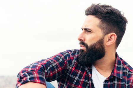 profile portrait of a handsome bearded man, concept of beauty and masculinity, copy space for textの写真素材