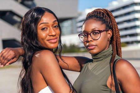 portrait of two young black friends posing looking at the camera, concept of friendship and urban...