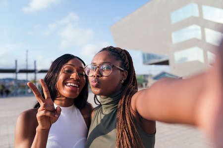 selfie photo of two young black friends having fun in the city, concept of youth and friendship, copy space for textの写真素材