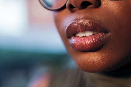close-up detail of the full-lipped mouth of a black woman, copy space for textの写真素材