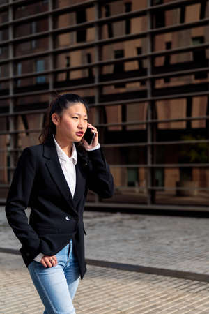 young asian businesswoman talking on the phone