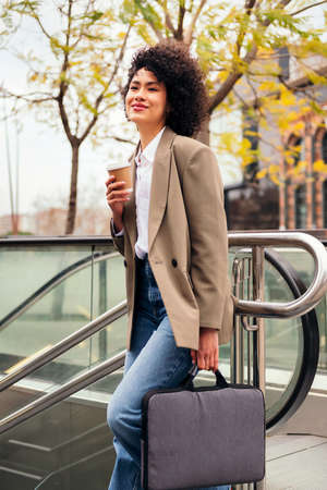 woman entering the subway station with a briefcaseの写真素材