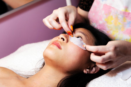preparation of a young woman to have her eyelashes trimmedの写真素材