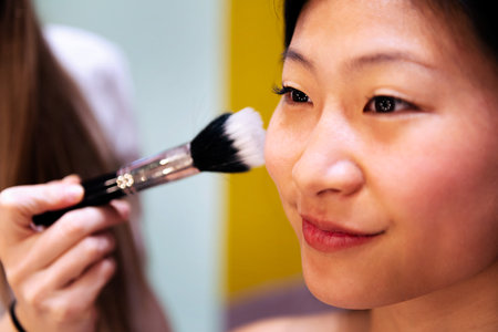 portrait of a woman receiving a professional makeupの写真素材