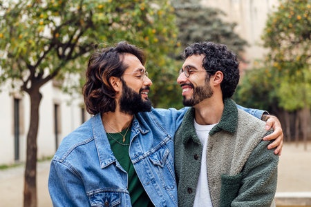 young couple of gay men looking into eyes tenderlyの写真素材