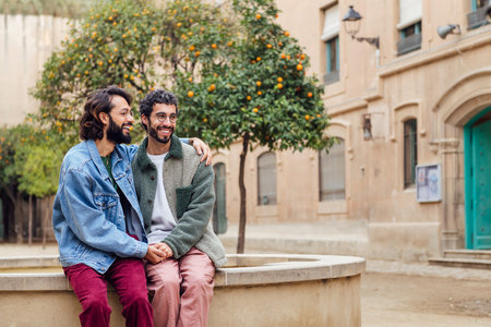 young couple of men smiling happy holding handsの写真素材