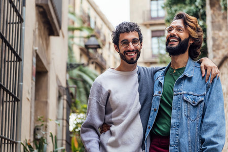 gay male couple embracing smiling happy in the streetの写真素材