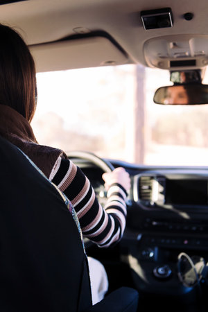 rear view of a young woman driving her camper vanの写真素材