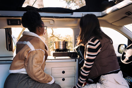 friends in a road trip cooking in camper van