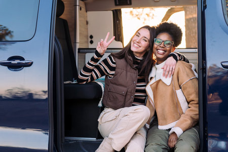 two women in a camper van having fun and smiling