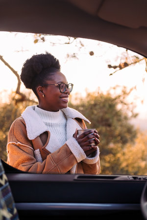 woman in a camper van smiling happy in natureの写真素材