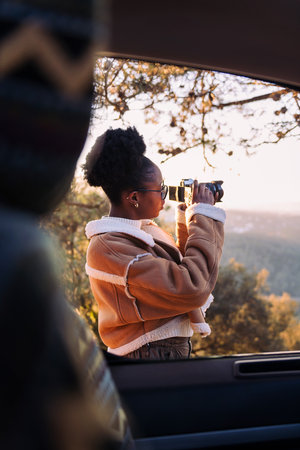 woman taking photos of nature during a road trip