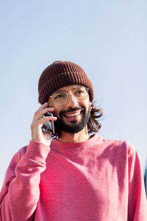 stylish young man talking on smart phone
