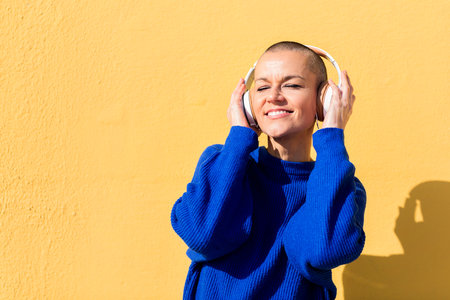 woman enjoying happy the music in her headphonesの写真素材