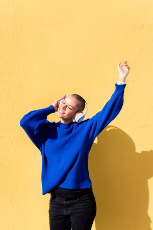 woman dancing listening to music in her headphonesの写真素材