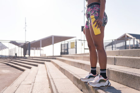 runner standing outdoors with a water bottleの写真素材