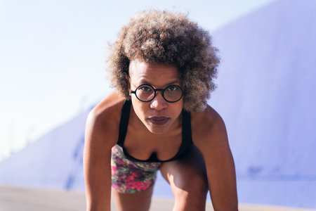 focused sportswoman in position to start a raceの写真素材