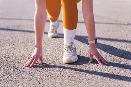 unrecognizable sportswoman ready to start race