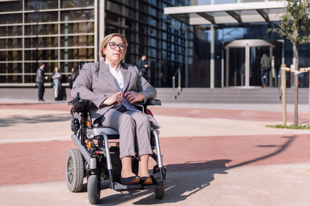 businesswoman using wheelchair at street