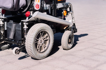 cropped photo of electric wheelchair on a sidewalk