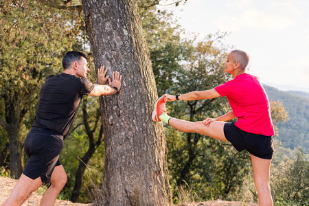 couple stretching for training in the nature