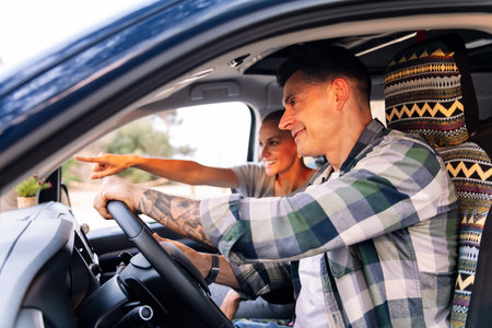 man and woman driving a camper van during