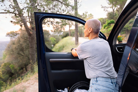 woman leaning on her van admiring the landscapeの写真素材