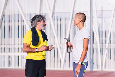 man talking with personal trainer before trainingの写真素材