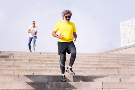 sports senior man training on stairs with trainer
