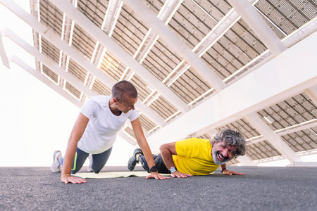 man laughing while training with personal trainerの写真素材