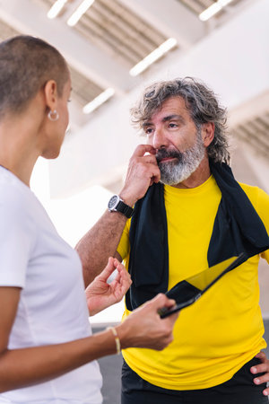 man and trainer watching progress of trainingの写真素材