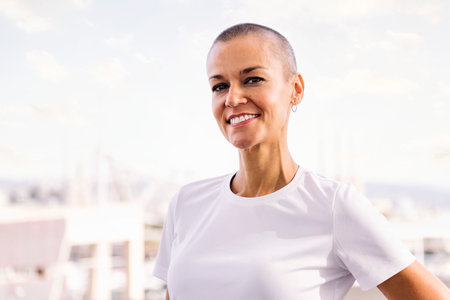 woman with shaved head smiling happy