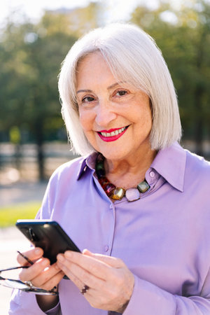senior woman smiling happy using mobile phone