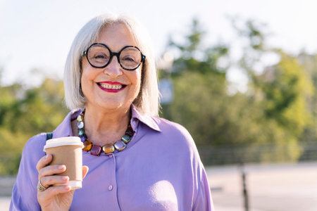 smiling senior woman with a takeaway coffee
