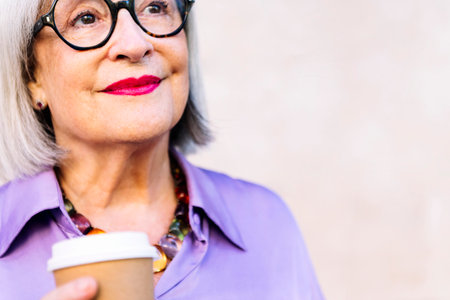 portrait of a smiling senior woman holding coffee