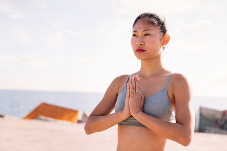 asian woman practicing yoga in pray position