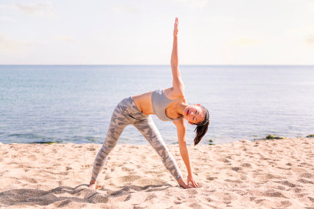 woman stretching on the beach with yoga poses