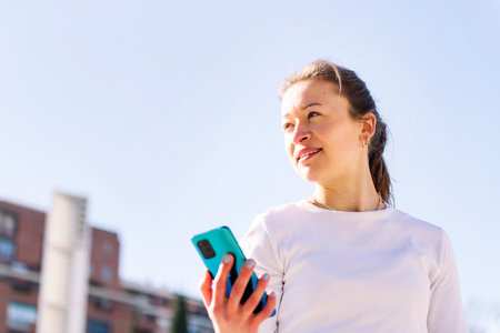 young caucasian woman using mobile phoneの写真素材