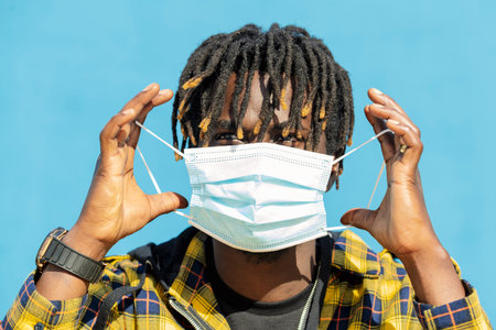 young black man wearing a protective maskの写真素材