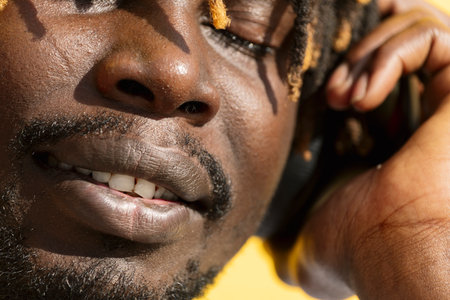 young african man listening to and enjoying musicの写真素材