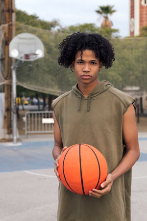 african american teen player with basket ballの写真素材